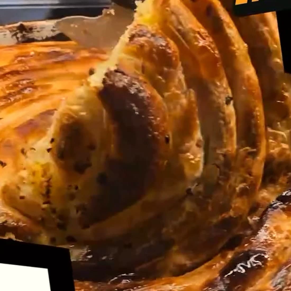 A slice of pita lifted from the round tepsija, layer by layer